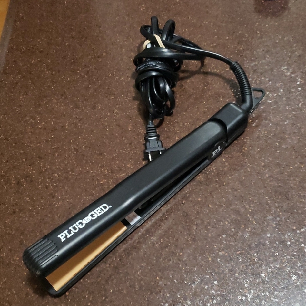 Plugged in HeatMaster 1-1/4 inch Ceramic Flat Iron.